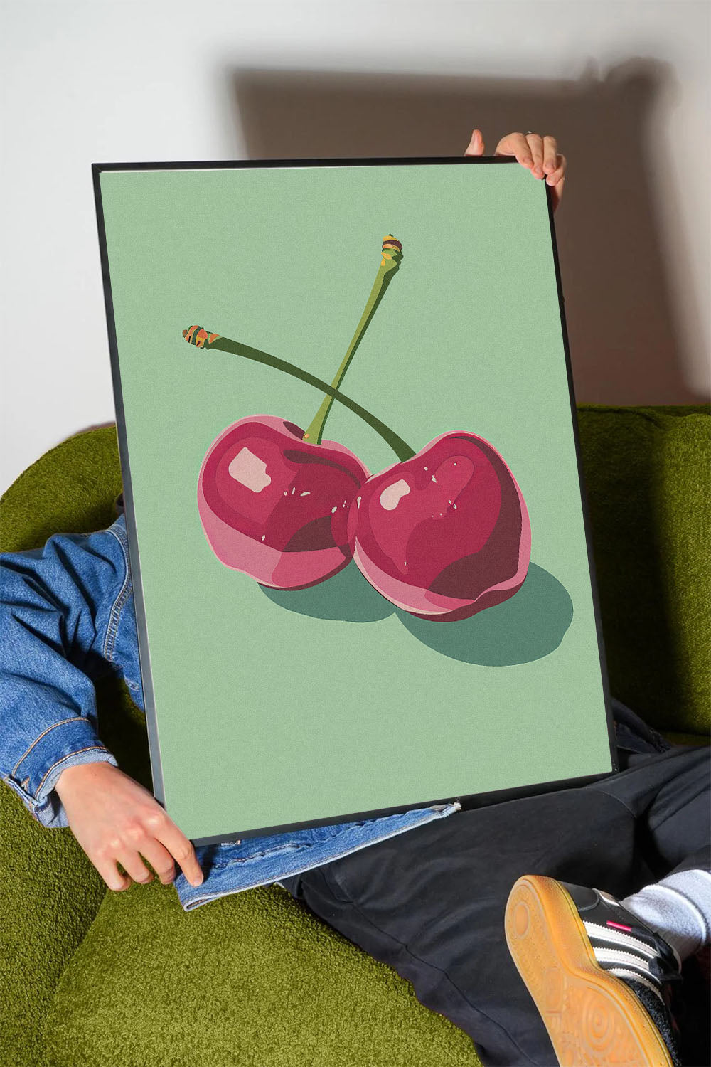 Siyah çerçeveli, açık yeşil fonda iki adet stilize pembe kiraz desenli modern poster.