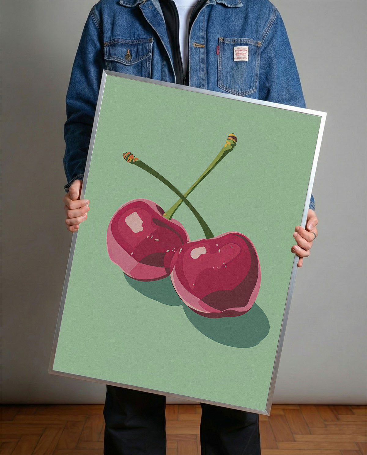 Siyah çerçeveli, açık yeşil fonda iki adet stilize pembe kiraz desenli modern poster.