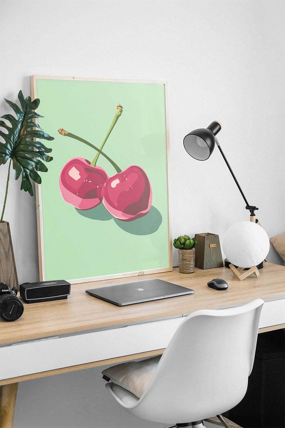 Siyah çerçeveli, açık yeşil fonda iki adet stilize pembe kiraz desenli modern poster.