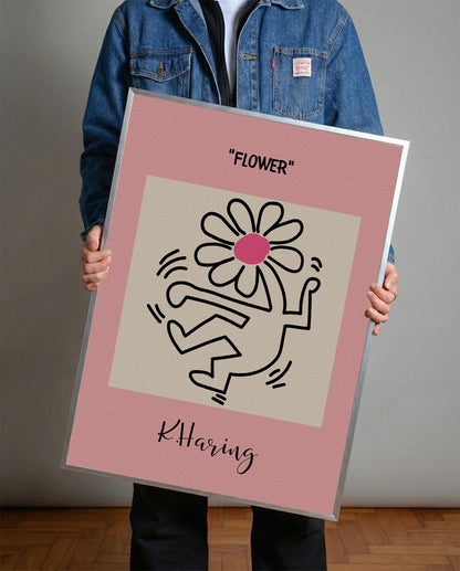 Keith Haring tarzı pembe arka planlı, neşeli çiçek tutan figürlü modern çerçeveli tablo