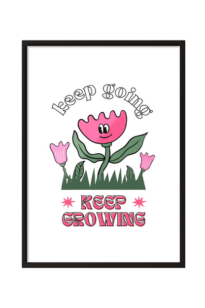 Siyah çerçeveli, beyaz zeminde pembe gülen çiçek, küçük çiçekler ve çimenler ile 'Keep Going' ve 'Keep Growing' yazılı motivasyon posteri.