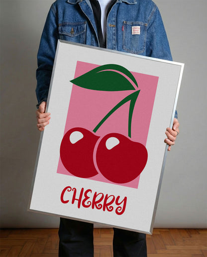 Pembe arka plan üzerinde iki kırmızı kiraz ve yeşil yaprakları olan modern çerçeveli poster