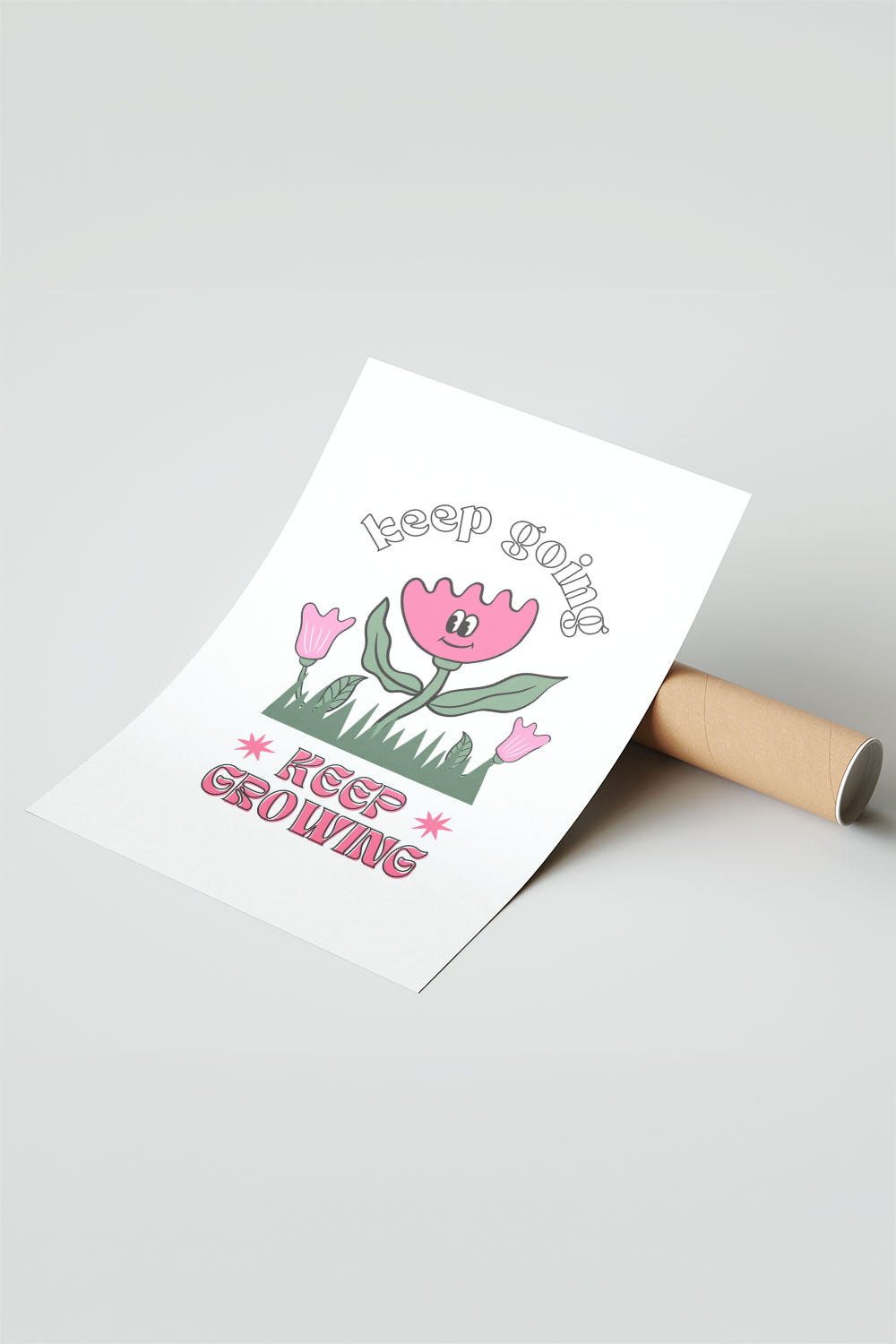 Siyah çerçeveli, beyaz zeminde pembe gülen çiçek, küçük çiçekler ve çimenler ile 'Keep Going' ve 'Keep Growing' yazılı motivasyon posteri.